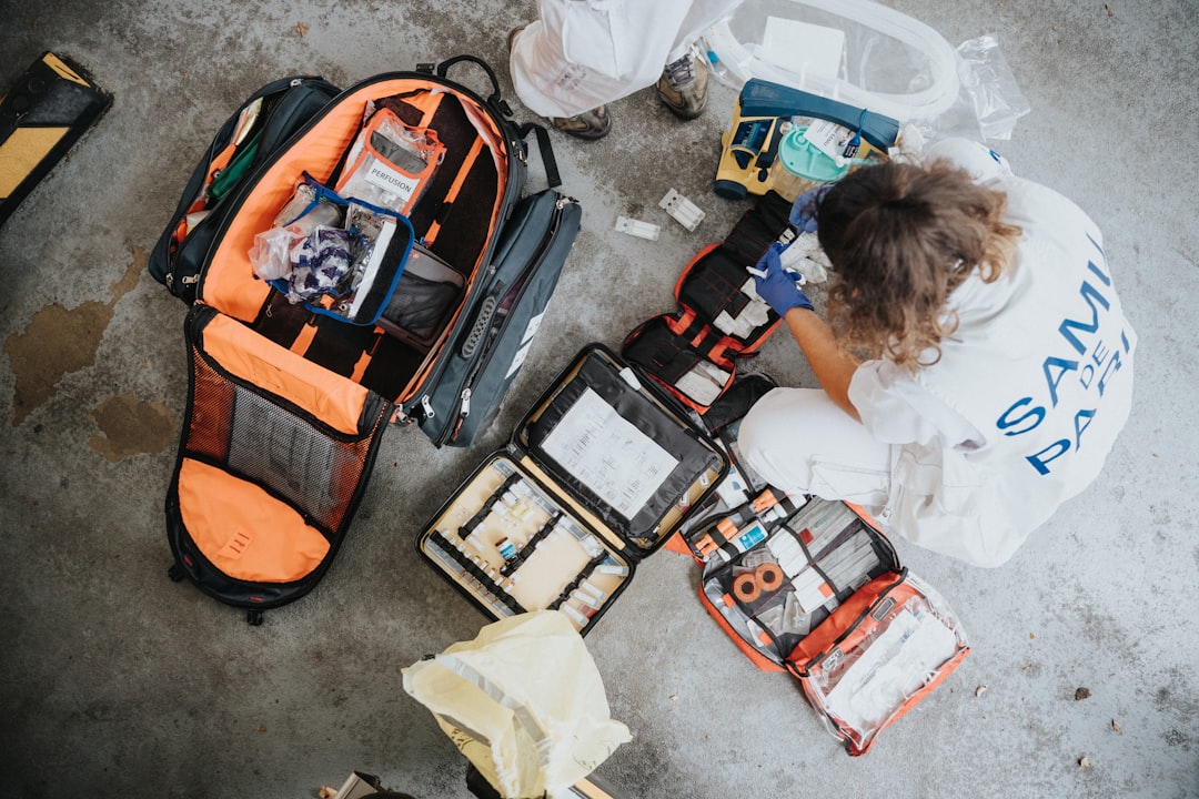 A family preparing an emergency go bag with essential items like water, food, and first aid supplies.